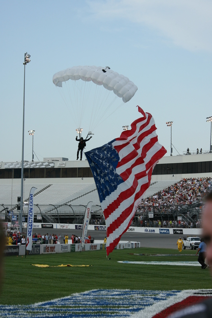 The parachute man arrives with the American Flag flying high before the start of the SunTrust Indy Challenge at Richmond International Raceway. -- Photo by: Chris Jones