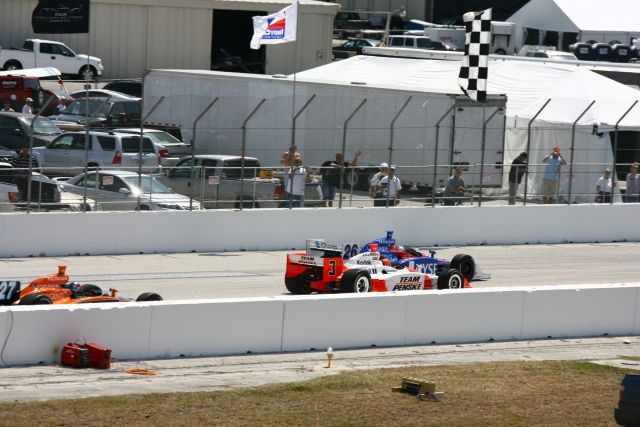 Number 26 driver, Marco Andretti barely taking the lead as number 3 driver, Helio Castroneves is fresh on his tail, while number 27 driver, Dario Franchitti is not far behind. -- Photo by: Jim Haines