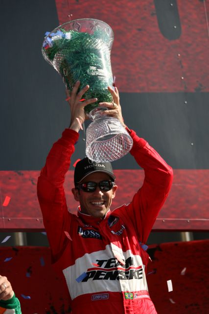 Helio Castroneves holding up his BIG prize. -- Photo by: Jim Haines