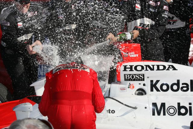 Team Penske spraying down the winner, Helio Castroneves, with bottles of champaign. -- Photo by: Shawn Payne