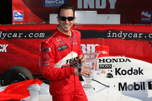 Helio Castroneves showing off his prizes. -- Photo by: Shawn Payne