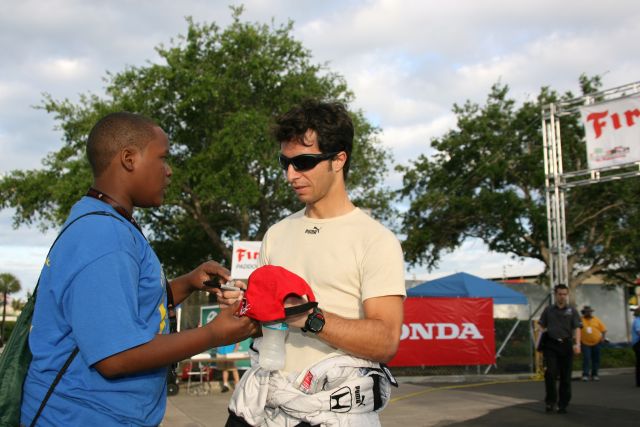 Dale Coyne Racing driver of the #18 Bruno Junqueira signs fans cap. -- Photo by: Chris Jones