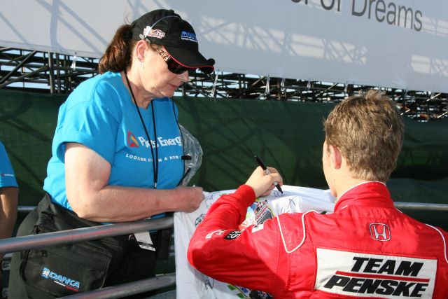 Ryan Briscoe signs an autograph for a lucky fan at St. Petersburg. -- Photo by: Chris Jones