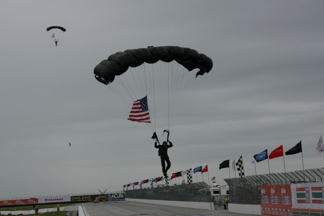 Parachutist make their way down during opening ceremonies. -- Photo by: Chris Jones
