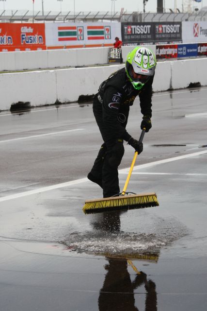 Crew member pushes-off water from pit lane prior to start of race. -- Photo by: Ron McQueeney
