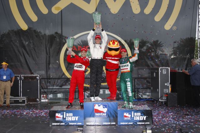 Race winner Graham Rahal, center poses with Firestone Firehawk, Helio Castroneves and Tony Kanaan. -- Photo by: Ron McQueeney