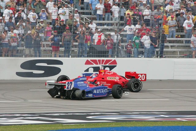 # 27 Andretti Green ArcaEx driver Dario Franchitti's car slides backwards while # 20 Tomas Enge passes -- Photo by: Ron McQueeney