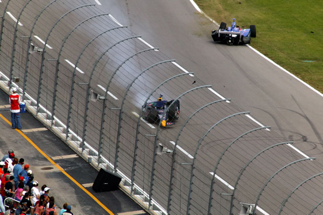 Both wrecked cars of Alex Barron, bottom, and Dario Franchitti come to rest on front staight -- Photo by: Shawn Payne