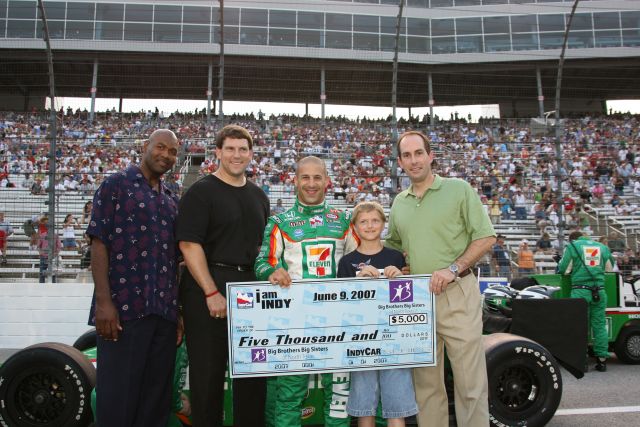 Tony Kanaan gives a check to Big Brothers and Big Sisters at Texas Motor Speedway before the Bombardier Learjet 550k. -- Photo by: Chris Jones