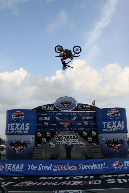 A member of the MD Extreme Stunt Show does a flip during pre race ceremonies at Texas Motor Speedway. -- Photo by: Shawn Payne