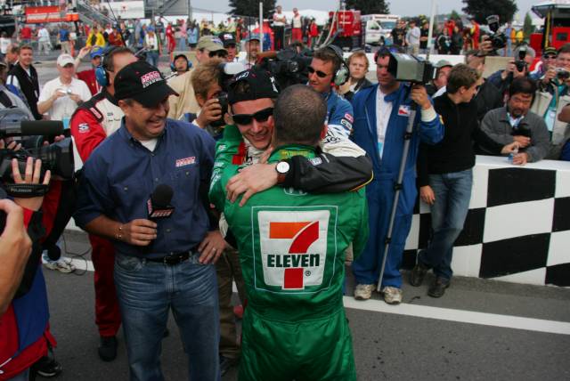 Dan Wheldon receives congratulations from teammate and 2004 series champion Tony Kanaan. -- Photo by: Ron McQueeney