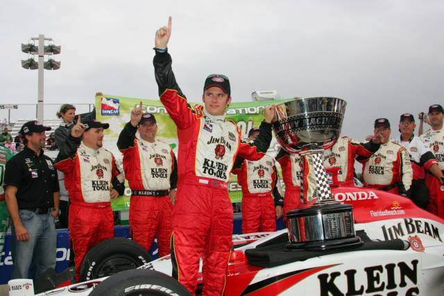 Dan Wheldon celebrates with the championship trophy. -- Photo by: Ron McQueeney