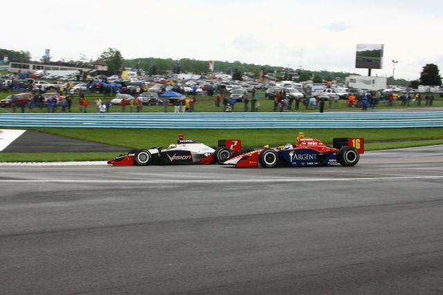 Tomas Scheckter (2) races Danica Patrick -- Photo by: Shawn Payne