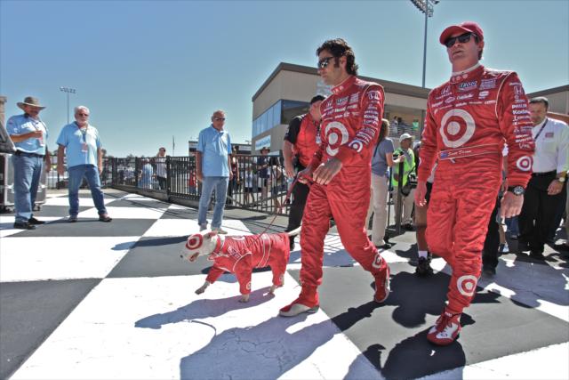 Dario Franchitti and Scott Dixon walking Bullseye the Target Dog to Victory Circle -- Photo by: Shawn Gritzmacher