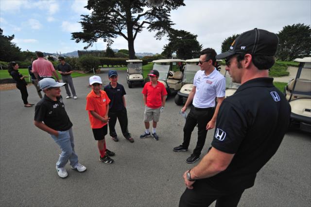 Simon Pagenaud and Mikhail Aleshin meet some young golfers at the Presidio Golf Course in San Francisco, CA -- Photo by: John Cote