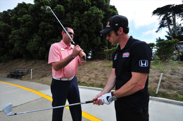 Simon Pagenaud gets a quick golf lesson at the Presidio Golf Course in San Francisco, CA -- Photo by: John Cote