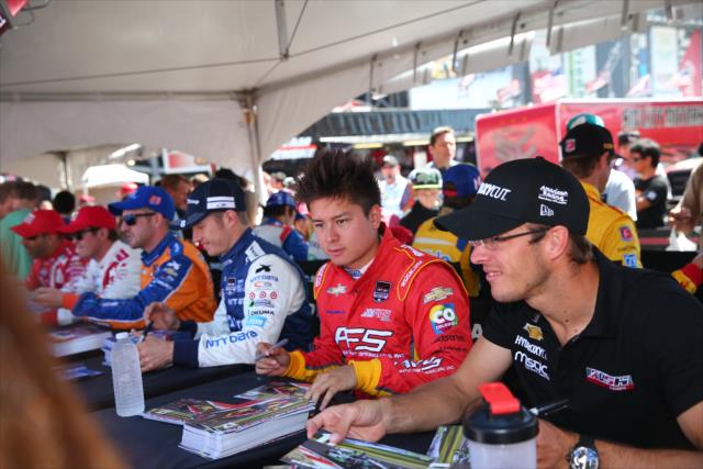 Teammates Sebastian Saavedra and Sebastien Bourdais among the drivers signing autographs in the INDYCAR Fan Village at Sonoma Raceway -- Photo by: Chris Jones