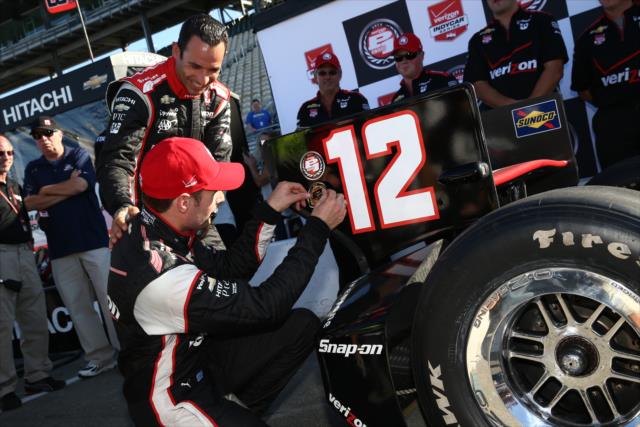 Will Power affixes the Verizon P1 Award emblem on his endplate as Helio Castroneves watches on -- Photo by: Chris Jones