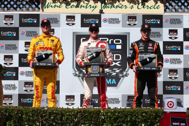 The podium of Scott Dixon, Ryan Hunter-Reay, & Simon Pagenaud with their trophies in Victory Lane at Sonoma Raceway -- Photo by: Chris Jones