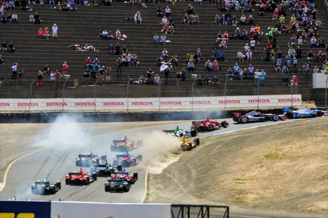 The field takes evasive maneuvers through Turn 2 during the start of the GoPro Grand Prix of Sonoma at Sonoma Raceway -- Photo by: John Cote