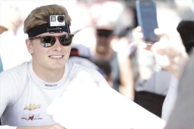 Josef Newgarden wears a head-mounted GoPro camera during the autograph session in the INDYCAR Nation Fan Village at Sonoma Raceway -- Photo by: Shawn Gritzmacher