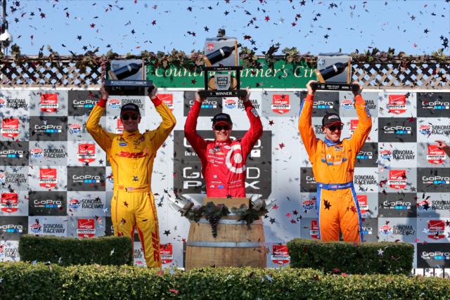 The podium of Scott Dixon, Ryan Hunter-Reay, and Charlie Kimball hoist their trophies in Victory Circle following the GoPro Grand Prix of Sonoma -- Photo by: Chris Jones