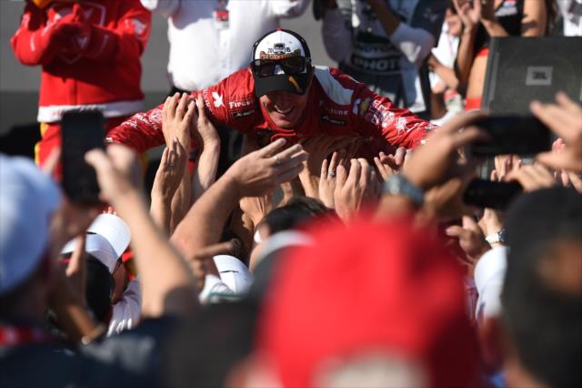 Scott Dixon crowdsurfs with the fans following becoming the 2015 Verizon IndyCar Series Champion -- Photo by: Chris Owens