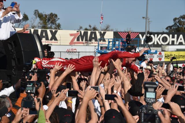 Scott Dixon crowd surfs with the fans after winning the 2015 Verizon IndyCar Series Champions -- Photo by: John Cote