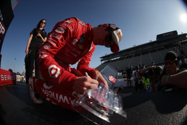 Scott Dixon signs an autograph following his win in the GoPro Grand Prix of Sonoma at Sonoma Raceway -- Photo by: Shawn Gritzmacher