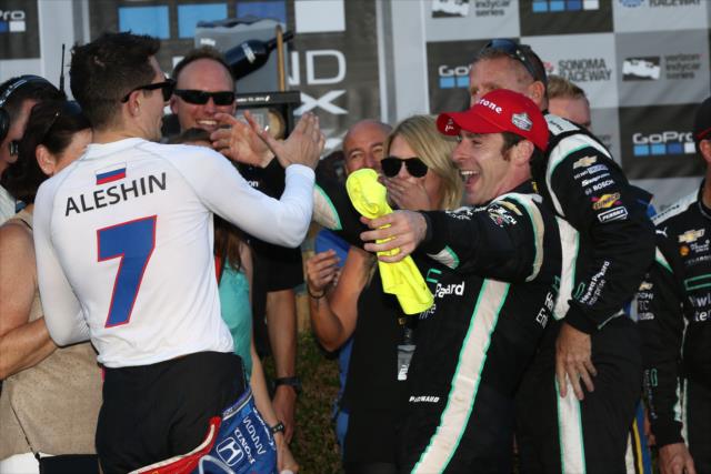 Former teammate Mikhail Aleshin congratulates Simon Pagenaud for winning the 2016 Verizon IndyCar Series championship -- Photo by: Chris Jones
