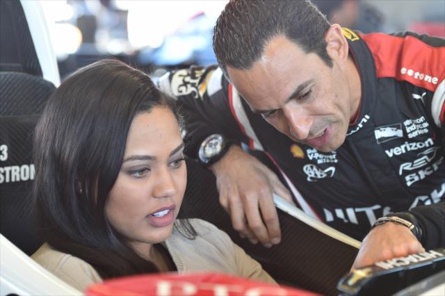 Helio Castroneves shows Grand Marshal Ayesha Curry some of the details of his No. 3 Hitachi Chevrolet at Sonoma Raceway -- Photo by: Chris Owens