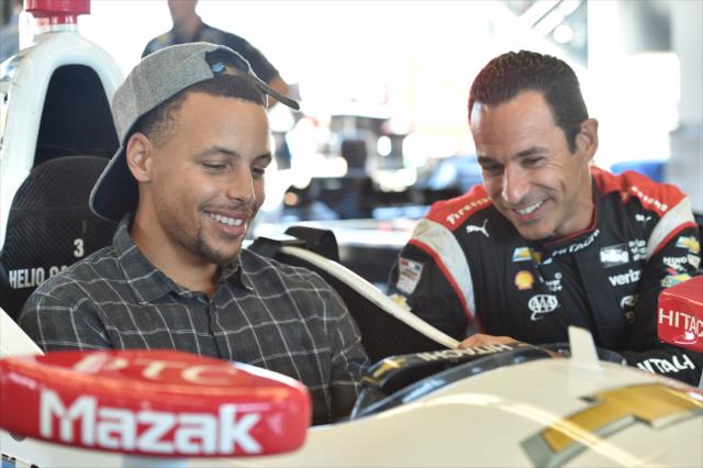 Helio Castroneves shows NBA superstar Stephen Curry some of the details of his car at Sonoma Raceway -- Photo by: Chris Owens