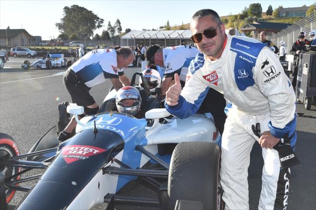 Actor Taylor Kinney with a thumbs-up following his two-seater ride by Mario Andretti around Sonoma Raceway -- Photo by: Chris Owens