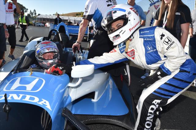 Grand Marshal Ayesha Curry thanks Mario Andretti for her two-seater ride around Sonoma Raceway -- Photo by: Chris Owens