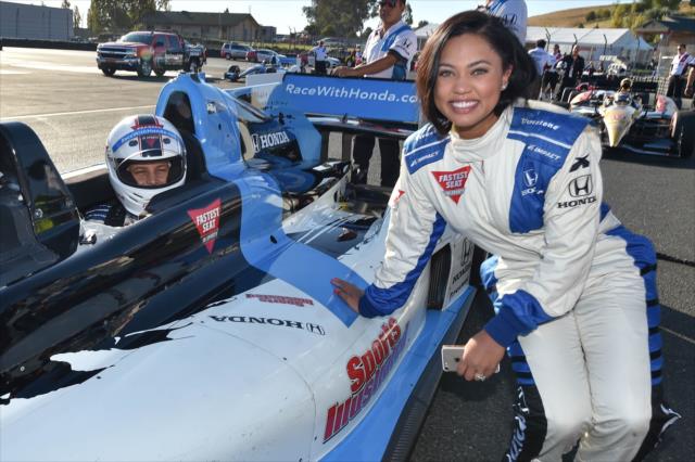 Grand Marshal Ayesha Curry poses with her husband, Stephan, in the INDYCAR two-seater at Sonoma Raceway -- Photo by: Chris Owens