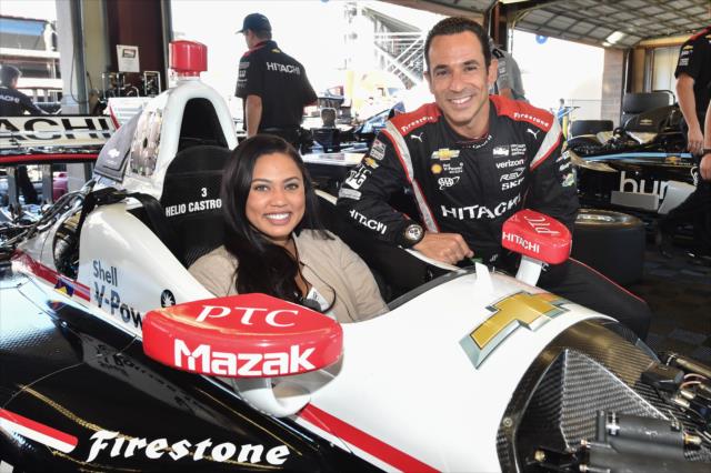 Helio Castroneves and Grand Marshal Ayesha Curry pose for a photograph in the Sonoma Raceway paddock area -- Photo by: Chris Owens