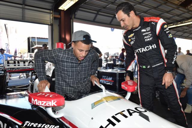 NBA Superstar Stephan Curry slides into Helio Castroneves's No. 3 Hitachi Chevrolet in the Sonoma Raceway paddock -- Photo by: Chris Owens