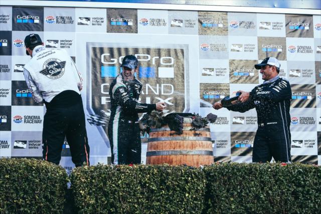 The champagne flies in Victory Lane between Simon Pagenaud, Graham Rahal, and Juan Pablo Montoya following the GoPro Grand Prix of Sonoma -- Photo by: Joe Skibinski