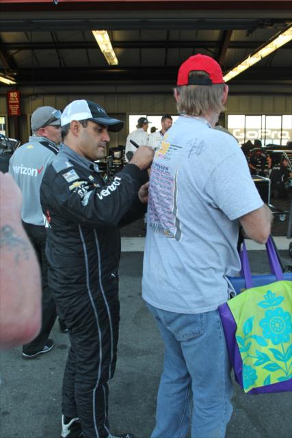 Juan Pablo Montoya signs an autograph following the GoPro Grand Prix of Sonoma -- Photo by: Richard Dowdy