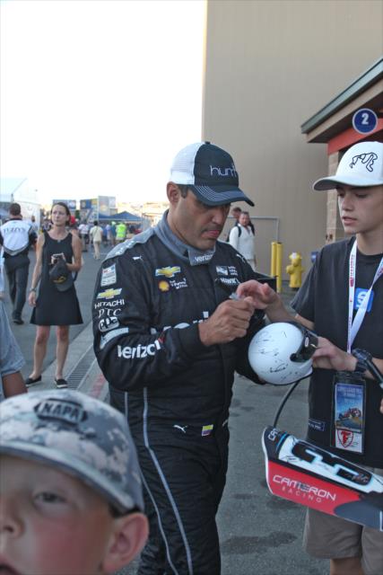 Juan Pablo Montoya signing an autograph back in the Sonoma Raceway paddock following the GoPro Grand Prix of Sonoma -- Photo by: Richard Dowdy