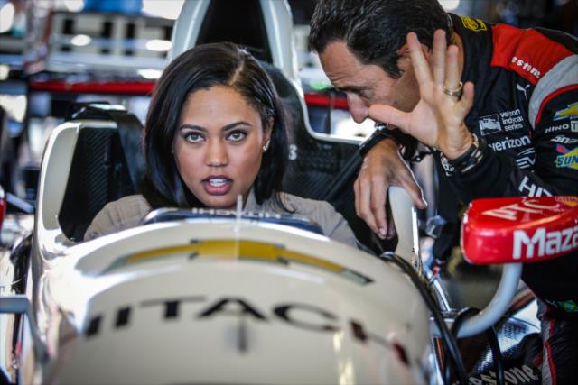 Helio Castroneves gives acclaimed chef and Grand Marshal Ayesha Curry a tour of his No. 3 Hitachi Chevrolet in the Sonoma Raceway paddock -- Photo by: Shawn Gritzmacher