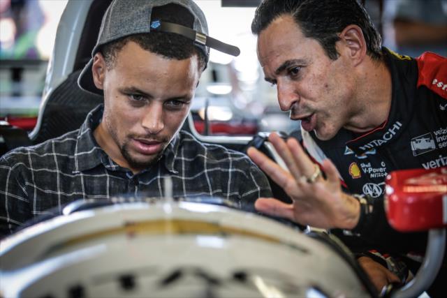 Helio Castroneves gives NBA All-Star Steph Curry a tour of his No. 3 Hitachi Chevrolet in the Sonoma Raceway paddock -- Photo by: Shawn Gritzmacher