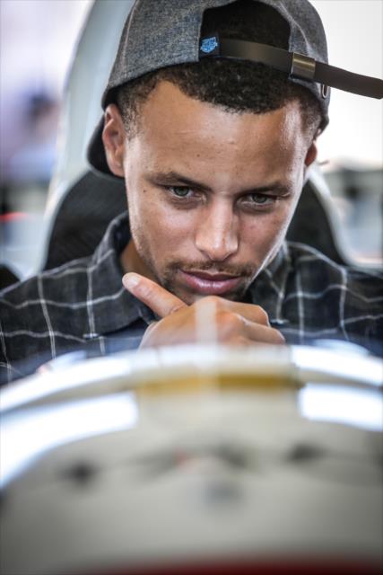 NBA All-Star Steph Curry sits in the No. 3 Hitachi Chevrolet in the Sonoma Raceway paddock -- Photo by: Shawn Gritzmacher