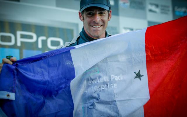 Simon Pagenaud displays the national flag of France in Victory Lane following his winning the GoPro Grand Prix of Sonoma -- Photo by: Shawn Gritzmacher