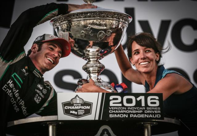 Simon Pagenaud and his personal assistant Krystin pose with the Astor Cup after winning the 2016 Verizon IndyCar Series Championship -- Photo by: Shawn Gritzmacher