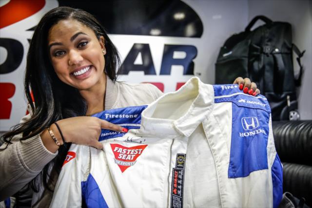 Acclaimed chef and Grand Marshal Ayesha Curry shows her firesuit prior to her two-seater ride around Sonoma Raceway -- Photo by: Shawn Gritzmacher