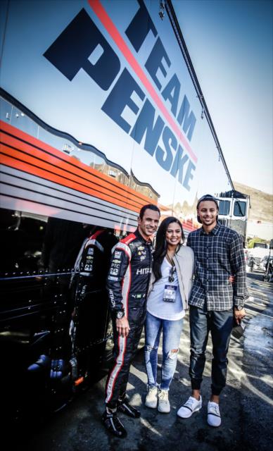 Helio Castroneves pose with Steph and Ayesha Curry next to the Team Penske transporter at Sonoma Raceway -- Photo by: Shawn Gritzmacher