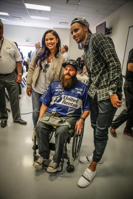 Steph and Ayesha Curry pose with veteran Army Sgt. Dan Rose at Sonoma Raceway -- Photo by: Shawn Gritzmacher