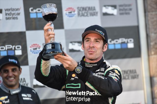 Simon Pagenaud hoists the winner's wine goblet in Victory Lane following his win in the GoPro Grand Prix of Sonoma -- Photo by: Chris Owens