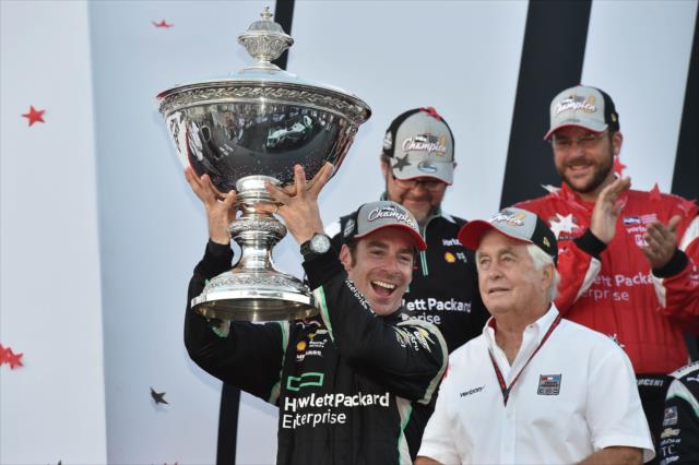 Simon Pagenaud hoists the Astor Cup as the 2016 Verizon IndyCar Series Champion for Team Penske and owner Roger Penske -- Photo by: Chris Owens